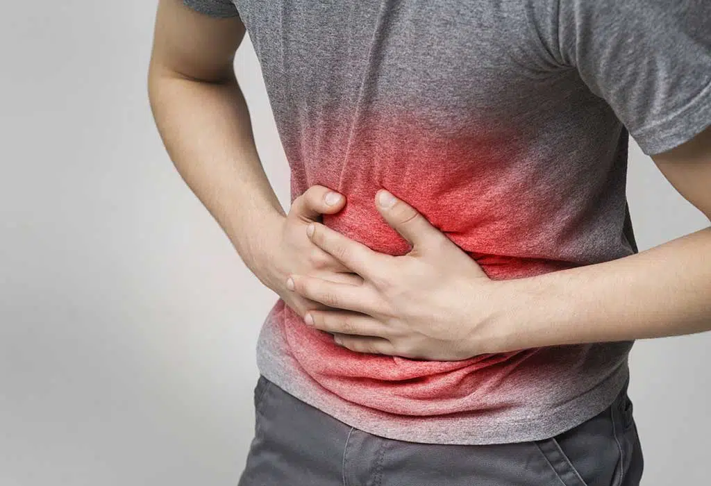 photo of man clutching stomach in pain