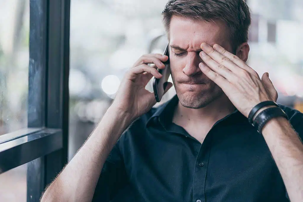 Photo of man on the phone, stressed