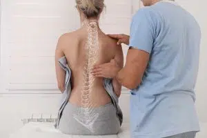 Photo of a doctor examining a woman's spine