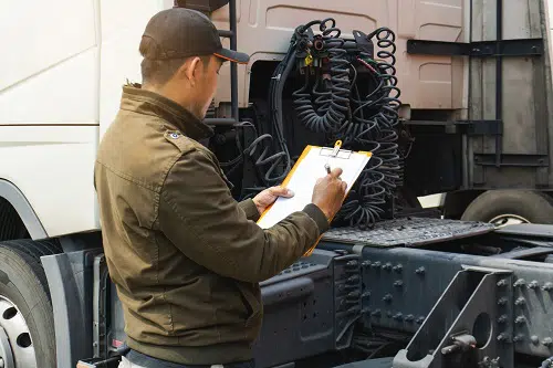 Man inspecting semi-truck