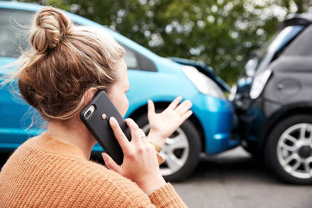 photo of a woman on the phone after an accident