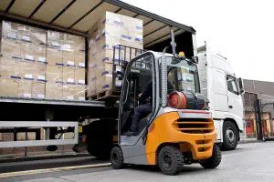 photo of a forklift unloading truck cargo
