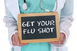 Doctor Holding Get Your Flu Shot Sign