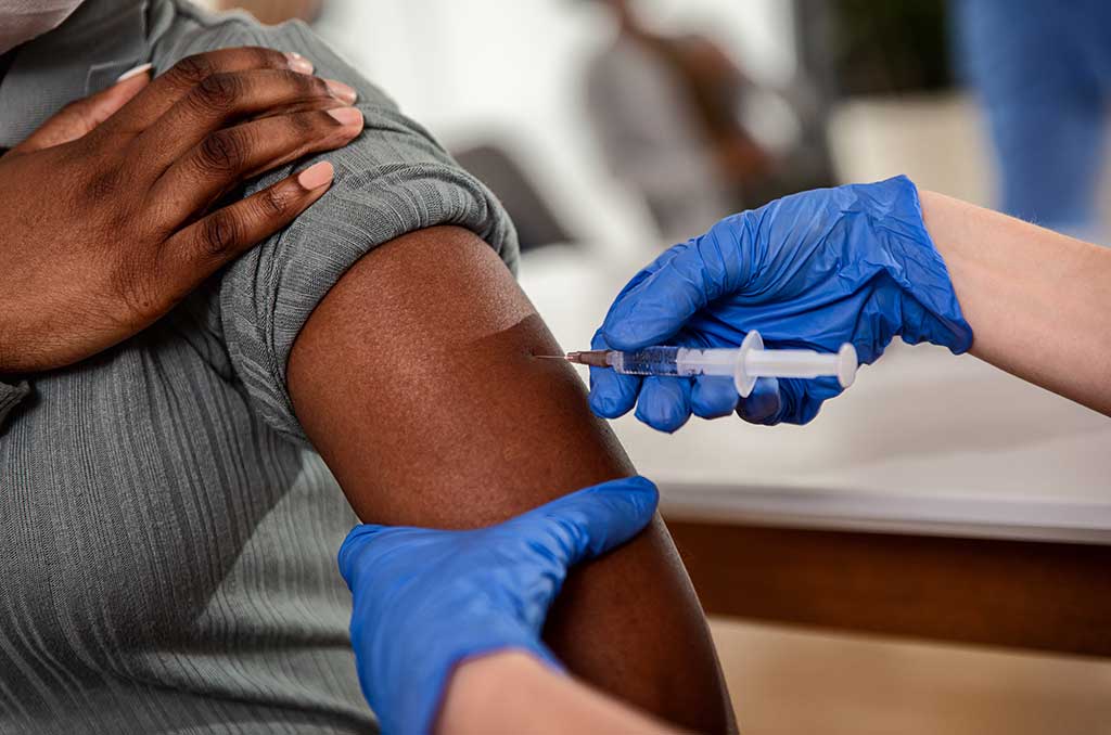 Photo of woman receiving vaccine from